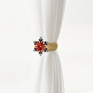 Detailed shot of Christmas red crystal snowflake curtain tieback with gold spring metal band.
