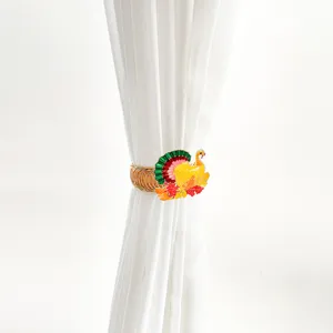 Thanksgiving turkey curtain tieback detail shot, metal spring clip with colorful maple leaves.