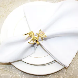 Exquisite gold geometric reindeer napkin ring detail showcasing elegant table setting decor.