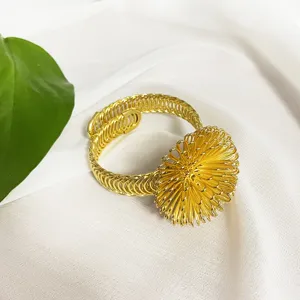 Golden metal wire-woven curtain tie-back ball, elegant drapery buckle and home decor accessory.
