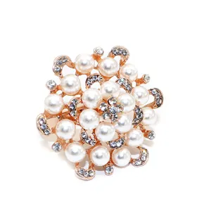 Detailed closeup of a luxury flower napkin ring with pearls and rhinestones for table decor.