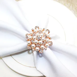 Exquisite pearl rhinestone napkin ring detail close-up, elegant floral table decor piece.