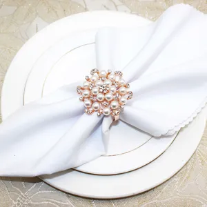 Detailed view of an elegant rose gold flower napkin ring featuring white pearls and sparkling rhinestones.