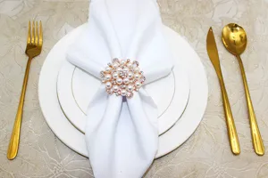 Pearl and rhinestone flower napkin ring detail, elegant table decor close up shot.