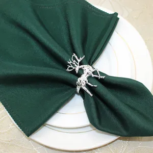 Silver reindeer napkin ring detail closeup, elegant Christmas table decor accessory.