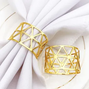 Gold metal napkin ring featuring a modern geometric hollow design for dining tables.
