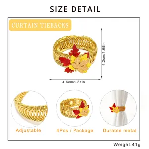 Detail view of gold metal curtain tieback featuring autumn maple leaves and adjustable spring.