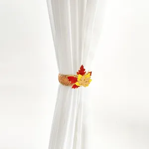 Detailed view of luxury metal spring curtain tieback featuring Thanksgiving maple leaves.