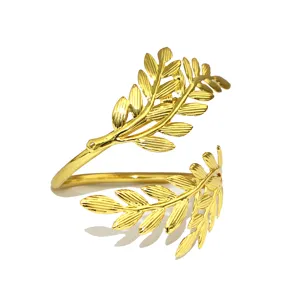 Gold metal leaf napkin ring detail view, elegant tableware accessory for restaurant dining table decor.