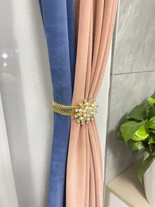 Detail shot of alloy spring curtain tieback decorated with pearl and rhinestone flowers for home.