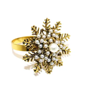 Gold snowflake napkin ring detail shot, vintage style table decor with artificial pearls.