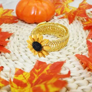 Gold metal spring curtain tieback with bright yellow sunflower decor, elegant autumn style.