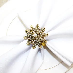 Detailed close-up view of a vintage gold snowflake napkin ring featuring elegant white faux pearls.