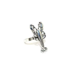 Close-up of vintage silver lobster napkin ring, featuring detailed metal marine design.