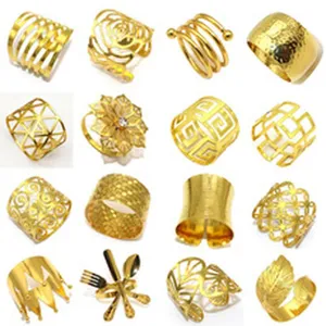 Gold metal napkin rings detail view showing various hollow out and geometric designs for table decor.
