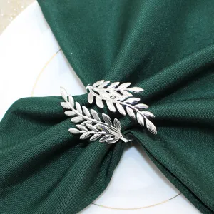 Silver leaf napkin ring detail view, elegant metal leaf decor for dining table settings.
