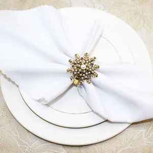 Antique gold snowflake napkin ring with pearls, elegant table decor for Christmas dinner parties.