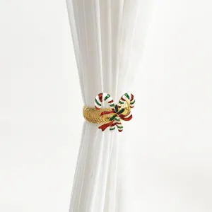 Detail shot of Christmas candy cane curtain tieback, metal spring clip for window decoration.