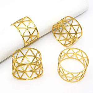 Gold metal napkin rings with geometric hollow triangle design for table decor and hotel dining setup.