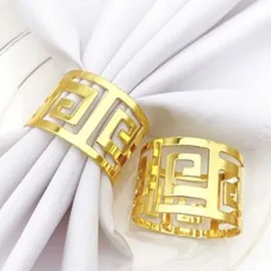 Detail shot of golden metal hollow geometric napkin rings, elegant tabletop decor.