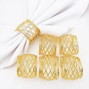 Detailed closeup of gold wire mesh napkin rings set, elegant table decor for dining.