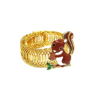 Gold metal spring curtain tieback with cute enamel squirrel decor for easy home window styling.