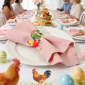Metal rooster napkin rings set for Easter party, elegant table decor with pink cloth napkins.