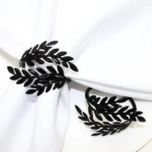 Detailed view of black leaf napkin ring, stylish metal table decor for dining table events.