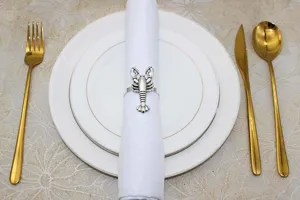 Vintage silver lobster napkin rings, metal marine life table decor for wedding party dinner.