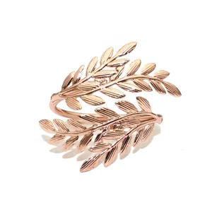 Detailed view of rose gold leaf napkin ring, elegant metallic table decor for restaurants.