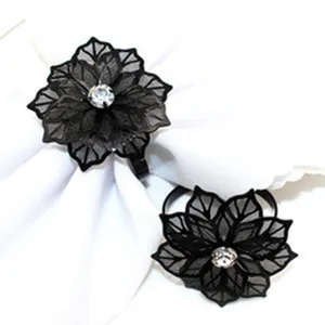 Black mesh flower napkin rings with rhinestone center for table decoration and wedding party setup.