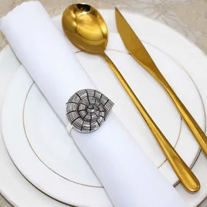 Detail view of vintage shell napkin ring, metal marine life napkin buckle for table decor.