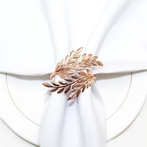 Rose gold metal leaf napkin ring detail shot, elegant table decor for restaurant settings.