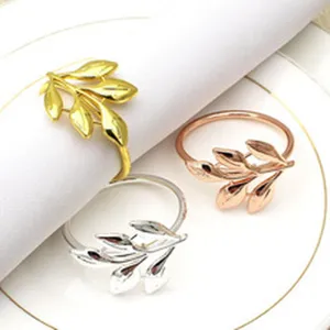 Leaf design metal napkin ring detail shot, elegant table decor in gold, silver, rose gold.