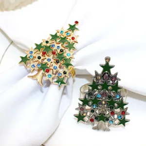 Detailed view of two Christmas tree napkin rings with colorful rhinestones and alloy base.