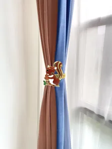 Cute squirrel curtain tieback detail, metal spring clip for home window decoration close up
