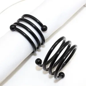 Black spiral napkin ring holder, minimalist table decor accessory for dinner parties and weddings.