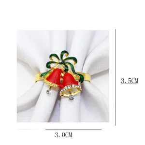 Vue détaillée de l'anneau de serviette cloche de Noël avec des cloches rouges et strass.