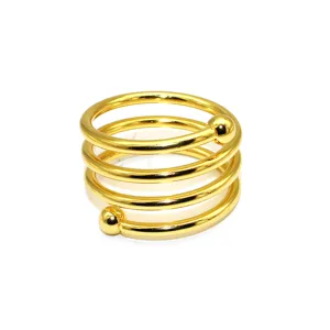 Gold metal spring napkin ring detail, spiral napkin holder with dual beads for table decor.