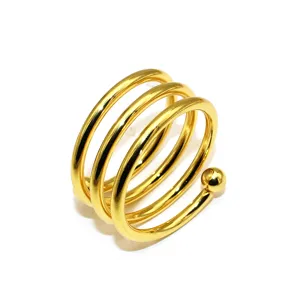 Close-up detail of the gold metal spring napkin ring, elegant spiral design for table decor.