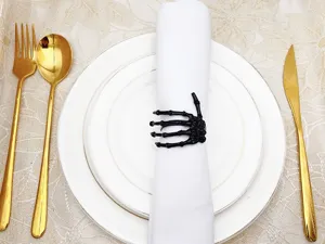 Halloween black skeleton hand napkin ring spooky table decor holder for party dinner setup.