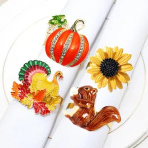 Detail view of autumn napkin rings featuring pumpkin, turkey, sunflower, and squirrel designs.