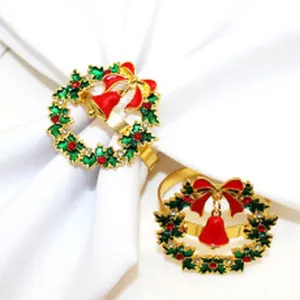 Close-up detail of Christmas napkin ring, gold alloy wreath and bell for holiday table.