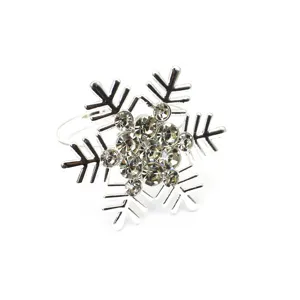 Detailed view of Christmas snowflake napkin ring with shiny rhinestones, silver alloy finish.