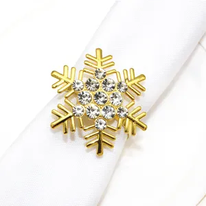 Detailed view of a gold Christmas snowflake napkin ring with sparkly rhinestones.