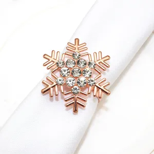 Closeup of a rose gold alloy snowflake napkin ring inlaid with sparkling rhinestones.