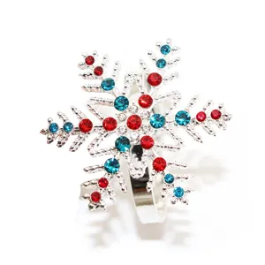 Exquisite rhinestone snowflake napkin ring detail shot, sparkling holiday table decor accent.