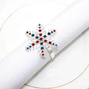 Close-up of a silver snowflake napkin ring with sparkling red and blue rhinestones detail
