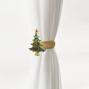 Detailed view of a green rhinestone Christmas tree curtain tieback holding a white curtain.