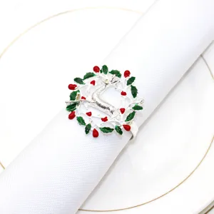 Detailed view of silver Christmas reindeer napkin ring featuring red and green festive decor elements.